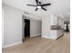 Open-concept area showing the kitchen and living room with light wood flooring and a ceiling fan at 2502 N 22Nd Dr, Phoenix, AZ 85009