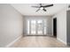 Bright living room with a ceiling fan, light wood floors, and a glass door leading to a patio at 2502 N 22Nd Dr, Phoenix, AZ 85009