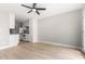 Open living space with plank flooring and a view into the modern kitchen at 2502 N 22Nd Dr, Phoenix, AZ 85009