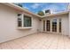 A tiled patio with a large window and glass doors that lead inside at 2502 N 22Nd Dr, Phoenix, AZ 85009