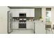 Modern kitchen with stainless steel appliances, white cabinetry, stone countertops, and ample counter space at 25041 N 174Th Ln, Surprise, AZ 85387