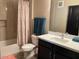 Well-lit bathroom with a shower-tub combo, complemented with a quartz counter and dark wood cabinets at 2511 W Queen Creek Rd # 244, Chandler, AZ 85248