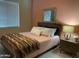 Relaxing bedroom with a full bed featuring designer lamps, mirror, and earth-tone walls at 2511 W Queen Creek Rd # 244, Chandler, AZ 85248