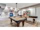 Entertaining game room with a pool table, shuffleboard, fireplace, and stylish lighting at 2511 W Queen Creek Rd # 244, Chandler, AZ 85248