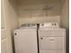 Convenient laundry room equipped with a modern washer and dryer, and overhead shelving at 2511 W Queen Creek Rd # 244, Chandler, AZ 85248