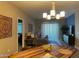 Inviting living room featuring a wooden dining table, modern lighting, and a decorative accent wall at 2511 W Queen Creek Rd # 244, Chandler, AZ 85248