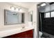 Updated bathroom features vanity with red cabinets and a shower at 2609 N Pleasant Dr, Chandler, AZ 85225