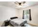 Simple bedroom with a bed, black nightstand, ceiling fan, and a window at 2609 N Pleasant Dr, Chandler, AZ 85225