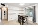 Dining area featuring a dark table, floating shelves, tiled floor, and bright lighting at 2609 N Pleasant Dr, Chandler, AZ 85225