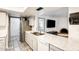 Bright kitchen with stainless steel appliances and stone countertops leading to a living room with a fireplace at 2609 N Pleasant Dr, Chandler, AZ 85225