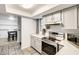 Bright kitchen with stainless steel appliances and white countertops, connected to dining area at 2609 N Pleasant Dr, Chandler, AZ 85225