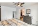 Spacious main bedroom with ceiling fan, dresser, closet and ensuite bathroom at 2609 N Pleasant Dr, Chandler, AZ 85225