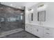 Luxurious bathroom with a glass enclosed shower, double vanity, and modern fixtures at 26631 S 169Th Pl, Queen Creek, AZ 85142