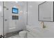 Bright bathroom with white tiling, glass-enclosed shower, and gold fixtures at 26631 S 169Th Pl, Queen Creek, AZ 85142