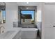 Bright bathroom featuring a modern tub with marble surround and exterior window view at 26631 S 169Th Pl, Queen Creek, AZ 85142