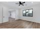 Bedroom features a window, a ceiling fan and wood floors with white walls and door at 26631 S 169Th Pl, Queen Creek, AZ 85142