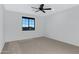 A neutral bedroom features carpet and a view from the window at 26631 S 169Th Pl, Queen Creek, AZ 85142