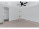 Bright bedroom with neutral carpet, a ceiling fan, and a walk-in closet at 26631 S 169Th Pl, Queen Creek, AZ 85142