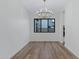 Dining room with modern chandelier, wood floors and large window at 26631 S 169Th Pl, Queen Creek, AZ 85142