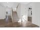 Bright entryway featuring wood floors, a staircase with black railings, and a view into another room at 26631 S 169Th Pl, Queen Creek, AZ 85142