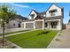 Inviting two-story home with fresh green lawn and a modern farmhouse design at 26631 S 169Th Pl, Queen Creek, AZ 85142