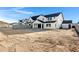 Modern home featuring a white exterior, black roof, and an unfinished front yard with cinderblock fencing at 26631 S 169Th Pl, Queen Creek, AZ 85142