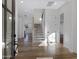 Bright foyer featuring wood flooring, a staircase, and crisp white walls at 26631 S 169Th Pl, Queen Creek, AZ 85142