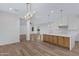Modern kitchen island overlooks the living room with white walls and wood floors at 26631 S 169Th Pl, Queen Creek, AZ 85142