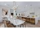 Modern kitchen and dining area with marble table, bar seating, and seamless flow to the living spaces at 26631 S 169Th Pl, Queen Creek, AZ 85142