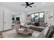 Inviting living room with a large sectional sofa, modern decor, and seamless flow to adjacent spaces at 26631 S 169Th Pl, Queen Creek, AZ 85142