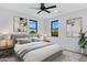 Serene main bedroom featuring a comfortable bed, modern lamps, and a view of the outside at 26631 S 169Th Pl, Queen Creek, AZ 85142