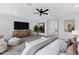 Bright bedroom featuring a black ceiling fan, large TV, and decor at 26631 S 169Th Pl, Queen Creek, AZ 85142