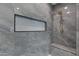 Detailed view of modern shower featuring marble tiling, built-in niche and seat, and gold fixtures at 26631 S 169Th Pl, Queen Creek, AZ 85142