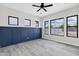 Bright bedroom with elegant wainscoting, wood-look floors, and a modern ceiling fan at 26643 S 169Th Pl, Queen Creek, AZ 85142