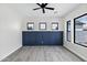 Stylish bedroom with elegant wainscoting, wood-look floors, and a modern ceiling fan at 26643 S 169Th Pl, Queen Creek, AZ 85142