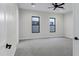 Spacious bedroom with neutral carpet, modern windows, and a stylish ceiling fan at 26643 S 169Th Pl, Queen Creek, AZ 85142
