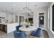 Cozy dining area featuring a round table with stylish blue chairs and modern lighting at 26643 S 169Th Pl, Queen Creek, AZ 85142