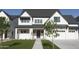 Gorgeous two-story home with white exterior, dark roof, and well-maintained artificial lawn at 26643 S 169Th Pl, Queen Creek, AZ 85142