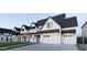 Beautiful two-story white home featuring dark roof, multiple windows, and attached garages at 26643 S 169Th Pl, Queen Creek, AZ 85142