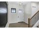 Beautifully lit foyer with sleek front door, wood floors, and stunning accent wall with staircase at 26643 S 169Th Pl, Queen Creek, AZ 85142