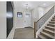 Inviting foyer with wood floors, modern light fixture, and stairs leading to the second floor at 26643 S 169Th Pl, Queen Creek, AZ 85142