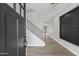 Beautifully lit foyer with sleek front door, wood floors, and stunning accent wall with staircase at 26643 S 169Th Pl, Queen Creek, AZ 85142