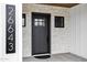 A close up of the front door, siding, and stone exterior of this beautiful new construction home at 26643 S 169Th Pl, Queen Creek, AZ 85142