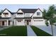 Inviting two-story home with a white exterior, dark roof, and a manicured green lawn at 26643 S 169Th Pl, Queen Creek, AZ 85142