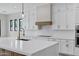 Modern kitchen with quartz countertops, white cabinetry, and a stainless steel appliances at 26643 S 169Th Pl, Queen Creek, AZ 85142