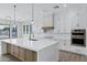 Modern kitchen featuring a large quartz island, white cabinets, and stainless steel appliances at 26643 S 169Th Pl, Queen Creek, AZ 85142