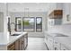 A modern, bright kitchen with an island, modern pendant lighting, and a contrasting hood at 26643 S 169Th Pl, Queen Creek, AZ 85142