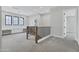 Open loft space with carpet flooring, black-framed windows, and built-in work space at 26643 S 169Th Pl, Queen Creek, AZ 85142