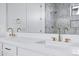 Bright bathroom featuring double sinks with white countertops and elegant gold fixtures at 26655 S 169Th Pl, Queen Creek, AZ 85142