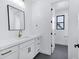 Well-lit bathroom with white cabinets, gold hardware, and a doorway to the water closet at 26655 S 169Th Pl, Queen Creek, AZ 85142